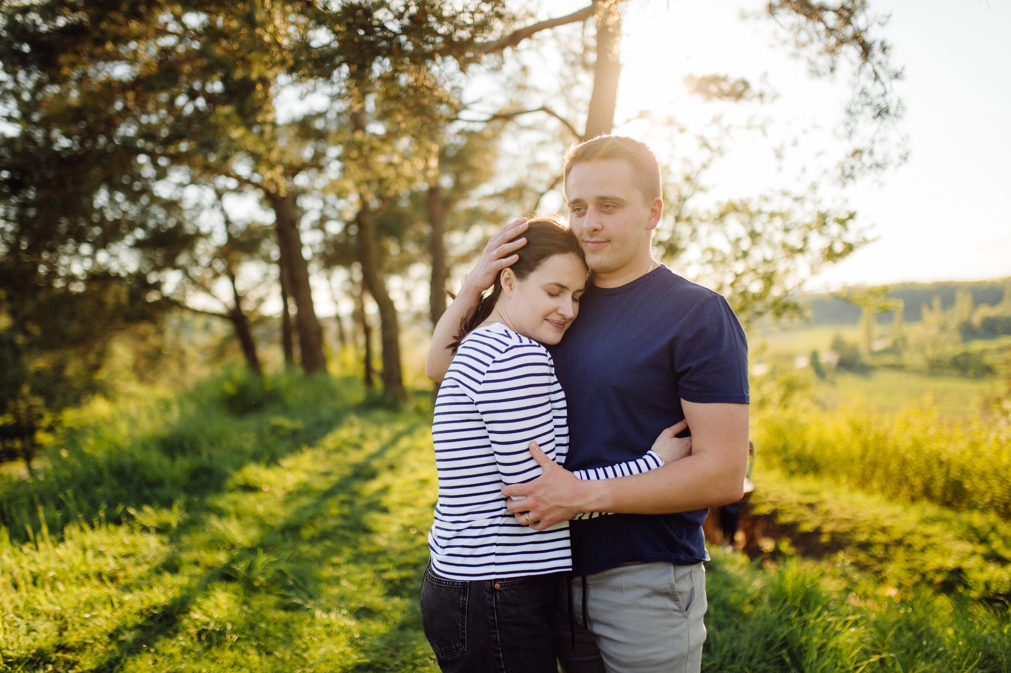 A young couple in love walks in the woods, having a good time together