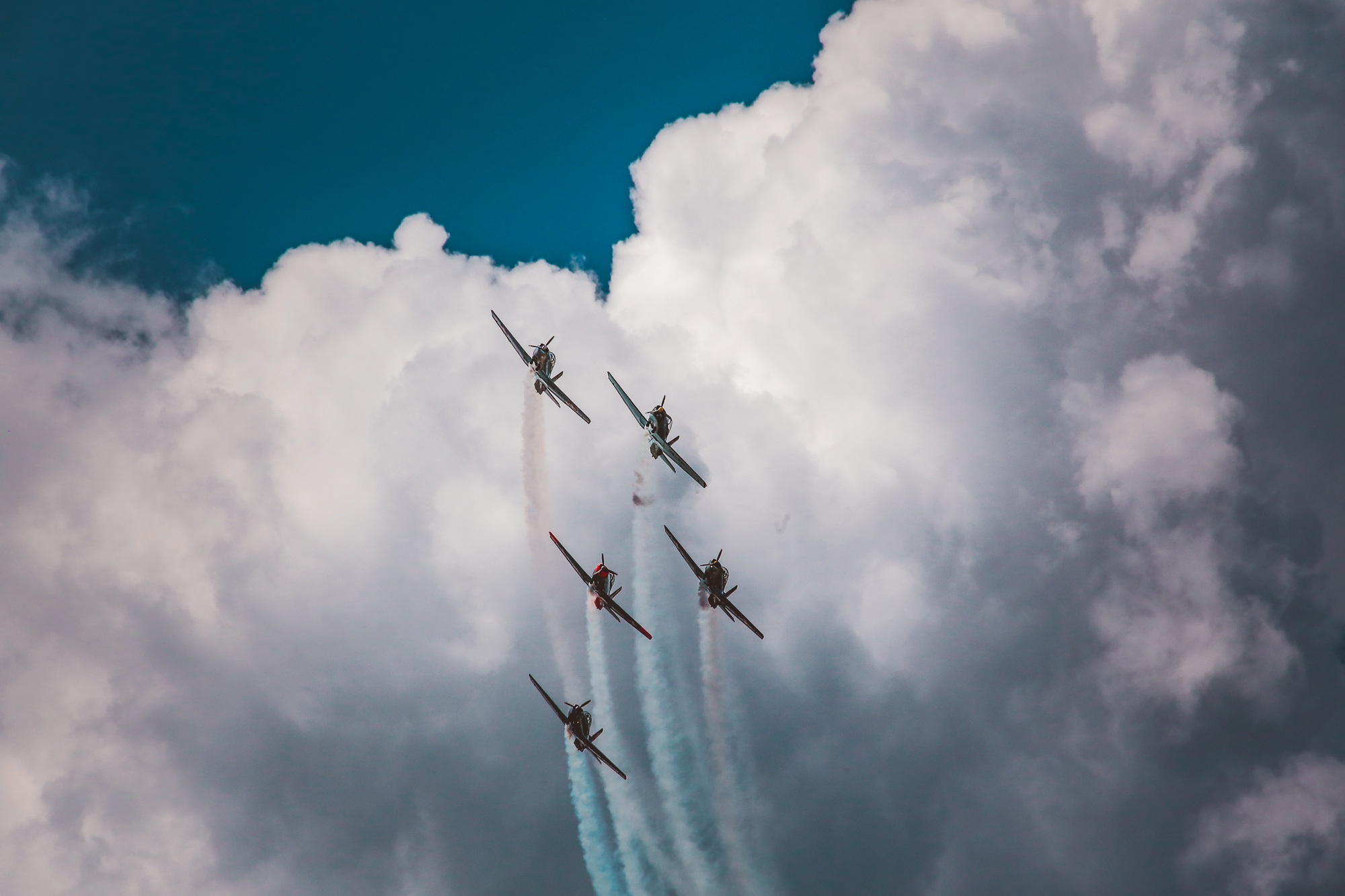 Low angle shot of a range of aircraft preparing an air show under the breathtaking cloudy sky