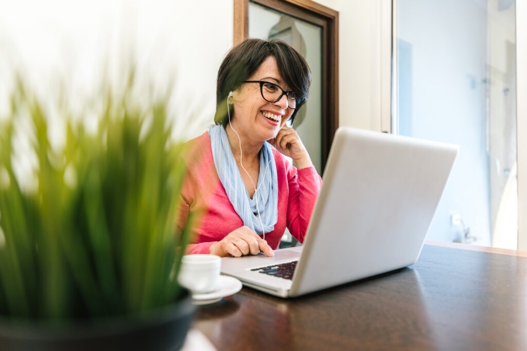 Mature woman using pc laptop indoor